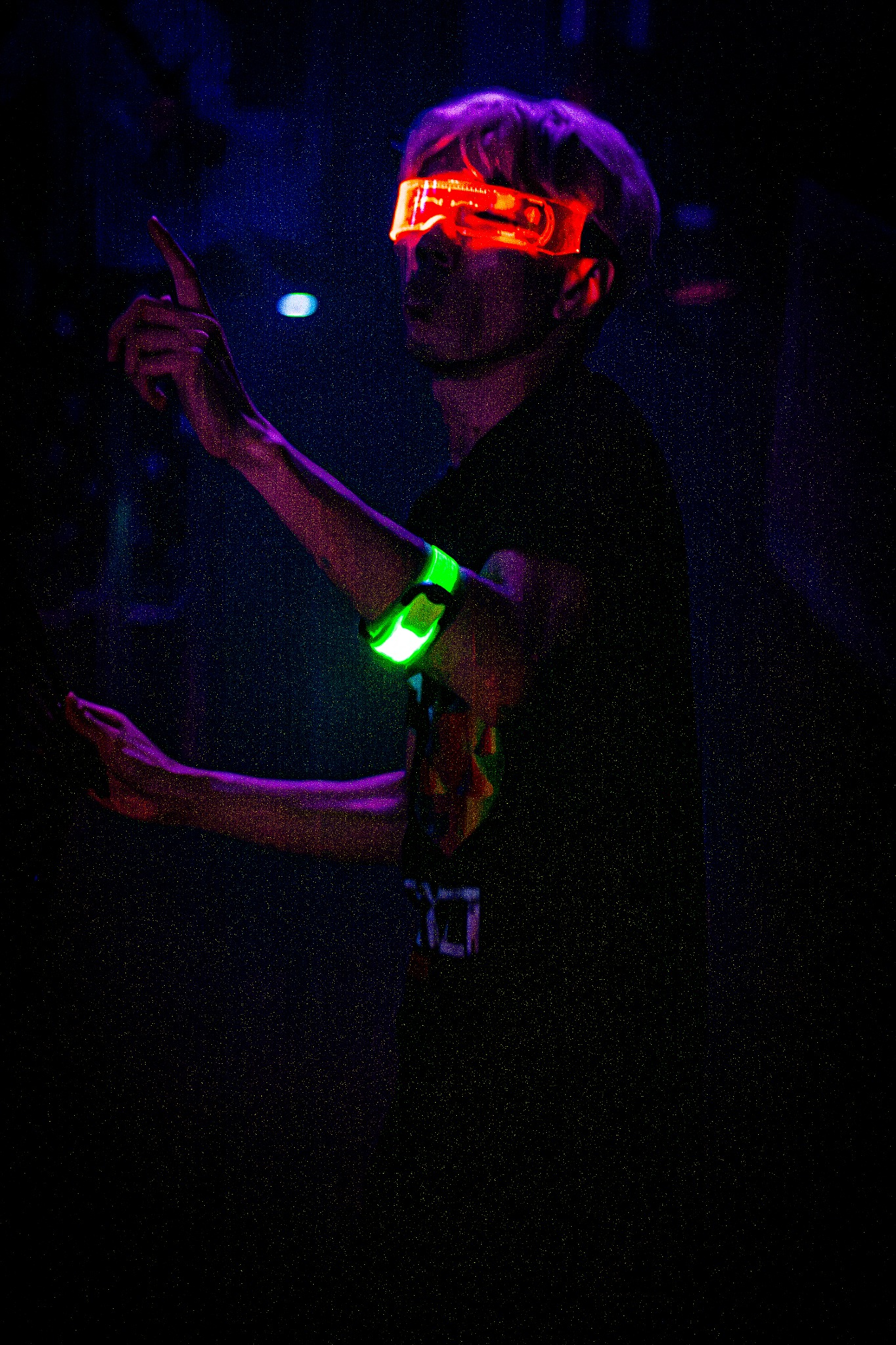 Performer dancing in ultraviolet event lighting